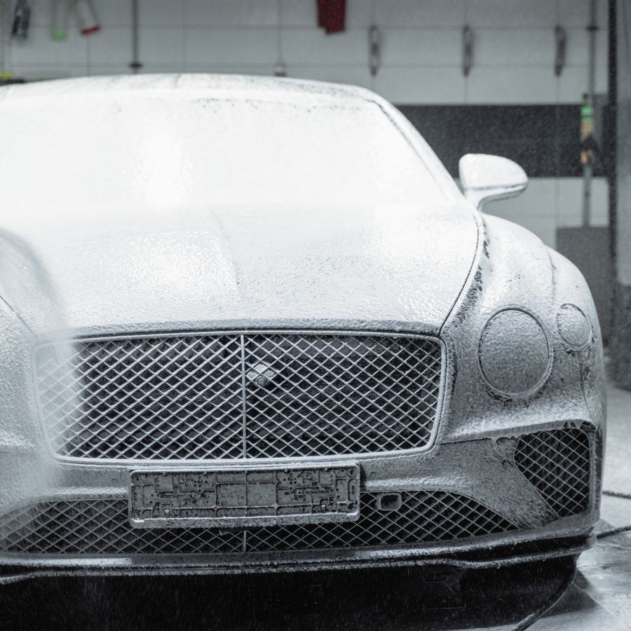 Car covered in cleaning foam during a wash